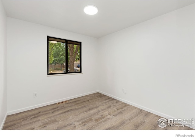 530 Mount Evans St, Longmont, CO 80504 - empty room with wood finished floors and baseboards