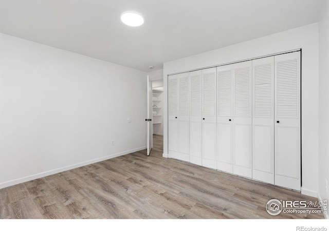 530 Mount Evans St, Longmont, CO 80504 - unfurnished bedroom featuring light wood-style floors and a closet