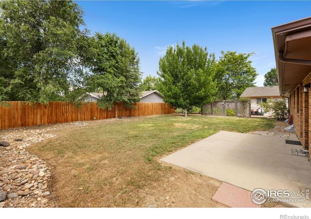 530 Mount Evans St, Longmont, CO 80504 - fenced backyard featuring a patio area