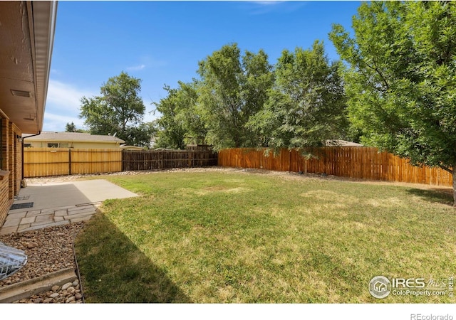530 Mount Evans St, Longmont, CO 80504 - fenced backyard featuring a patio