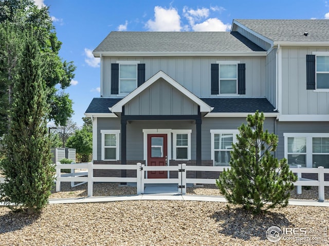 3038 County Fair Ln Unit 1, Fort Collins, CO 80528 - view of front facade featuring covered porch, a fenced front yard, and roof with shingles