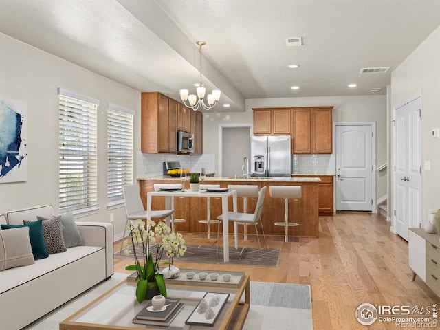 3038 County Fair Ln Unit 1, Fort Collins, CO 80528 - living area featuring light wood-style floors, a chandelier, and recessed lighting
