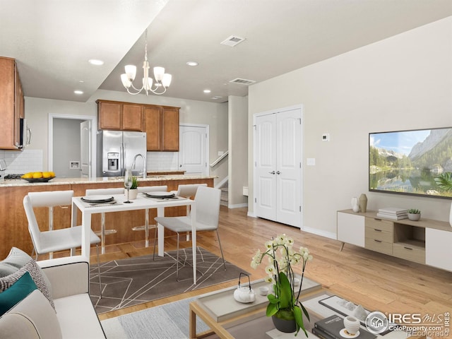3038 County Fair Ln Unit 1, Fort Collins, CO 80528 - living area with light wood-type flooring, recessed lighting, and a chandelier