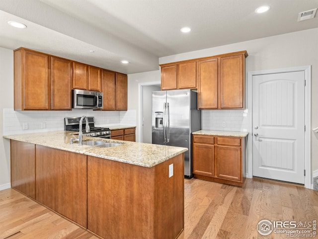 3038 County Fair Ln Unit 1, Fort Collins, CO 80528 - kitchen featuring stainless steel appliances, brown cabinetry, light wood-style flooring, and recessed lighting