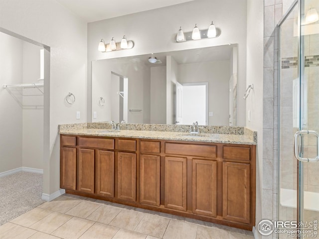 3038 County Fair Ln Unit 1, Fort Collins, CO 80528 - bathroom with double vanity, a shower stall, a spacious closet, and tile patterned flooring