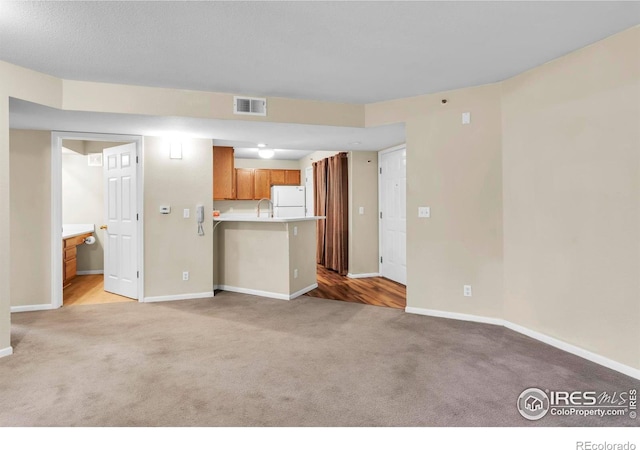 1830 W Centennial Dr Unit 108, Louisville, CO 80027 - unfurnished living room featuring light carpet and baseboards