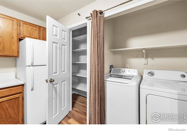 1830 W Centennial Dr Unit 108, Louisville, CO 80027 - washroom with light wood-type flooring and washing machine and dryer