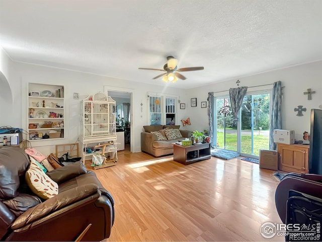 329 S Wynona Ave, Holyoke, CO 80734 - living room with a ceiling fan, light wood finished floors, and a textured ceiling