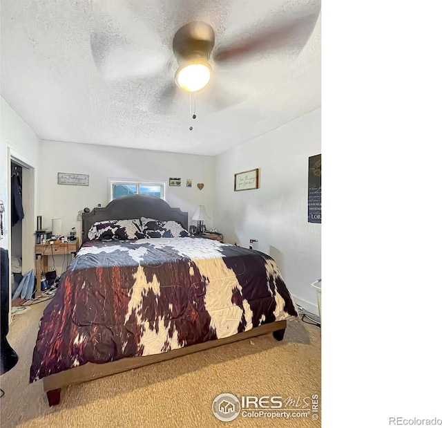 329 S Wynona Ave, Holyoke, CO 80734 - bedroom featuring carpet flooring, a textured ceiling, and a ceiling fan