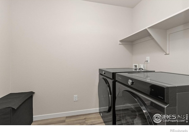 963 Milner Pass Rd, Severance, CO 80550 - laundry area with washer and dryer and light wood-style floors
