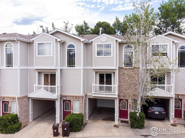 4919 Noble Park Pl, Boulder, CO 80301 - townhome / multi-family property featuring a garage, driveway, and brick siding
