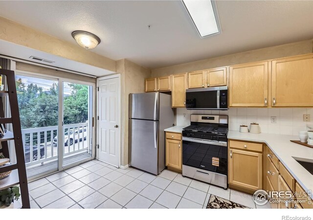 4919 Noble Park Pl, Boulder, CO 80301 - kitchen with stainless steel appliances, light brown cabinetry, light countertops, and tasteful backsplash