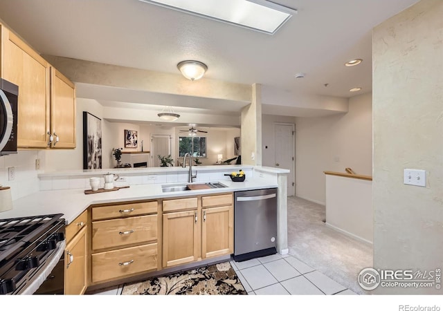4919 Noble Park Pl, Boulder, CO 80301 - kitchen with appliances with stainless steel finishes, light brown cabinetry, a peninsula, light carpet, and recessed lighting