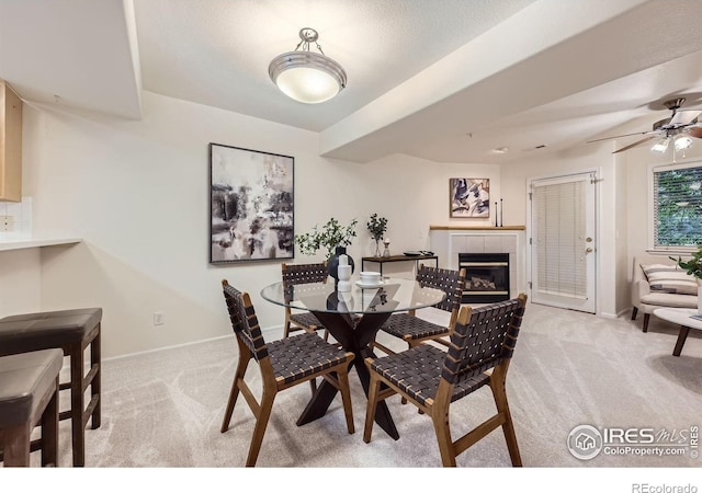 4919 Noble Park Pl, Boulder, CO 80301 - dining room with light carpet, ceiling fan, and a fireplace
