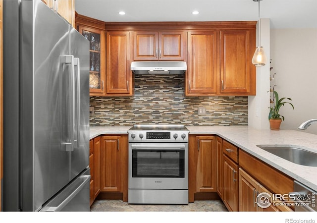 337 Arapahoe Ave Unit 303, Boulder, CO 80302 - kitchen with stainless steel appliances, under cabinet range hood, brown cabinetry, and recessed lighting