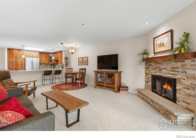 337 Arapahoe Ave Unit 303, Boulder, CO 80302 - living room with light colored carpet, a stone fireplace, and recessed lighting