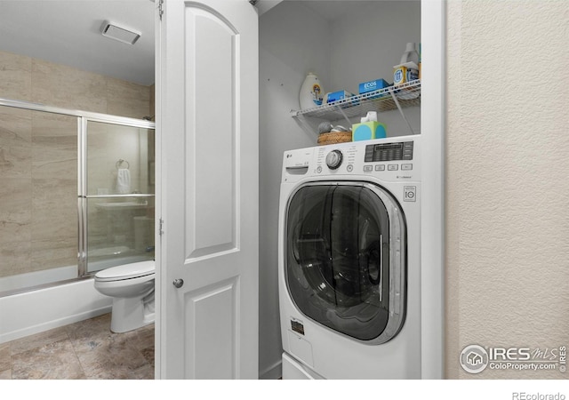 337 Arapahoe Ave Unit 303, Boulder, CO 80302 - laundry area with washer / clothes dryer and a textured wall