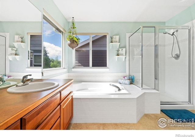 8119 Lighthouse Ln, Windsor, CO 80528 - bathroom with vanity, tile patterned floors, a shower stall, and a garden tub