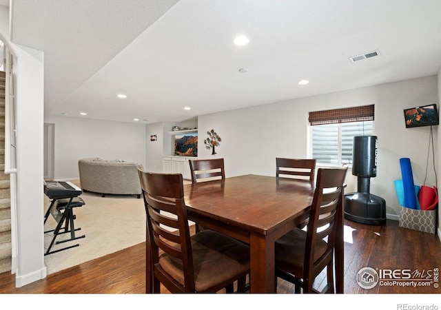 8119 Lighthouse Ln, Windsor, CO 80528 - dining area with wood-type flooring, recessed lighting, and stairway