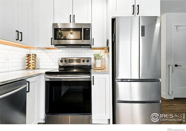 3850 Broadway St Unit 24, Boulder, CO 80304 - kitchen featuring stainless steel appliances, light stone countertops, backsplash, and dark wood-style floors