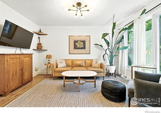 3850 Broadway St Unit 24, Boulder, CO 80304 - living room featuring a chandelier and light wood-type flooring