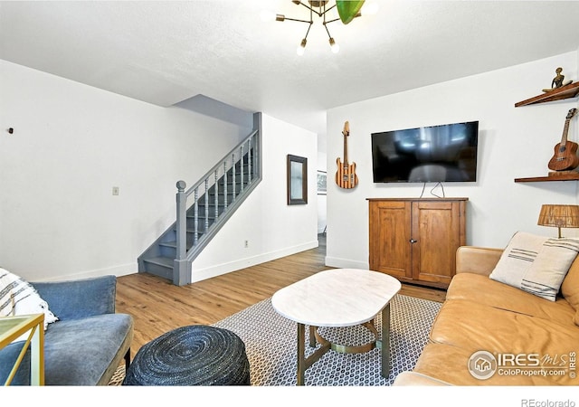3850 Broadway St Unit 24, Boulder, CO 80304 - living room featuring stairs, wood finished floors, and a chandelier