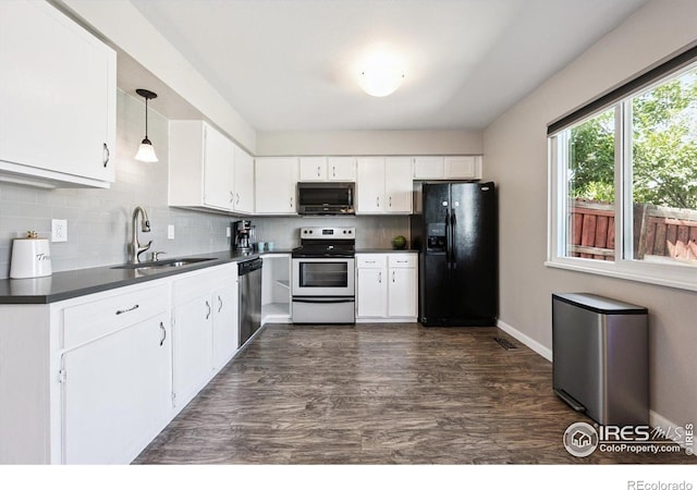 1119 Milky Way, Thornton, CO 80260 - kitchen featuring appliances with stainless steel finishes, dark countertops, and tasteful backsplash