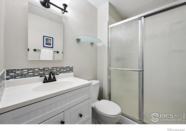 1119 Milky Way, Thornton, CO 80260 - full bathroom featuring backsplash, a shower stall, and vanity