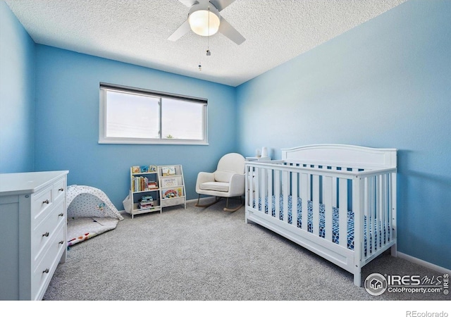 1119 Milky Way, Thornton, CO 80260 - bedroom with carpet flooring, a nursery area, a textured ceiling, and a ceiling fan