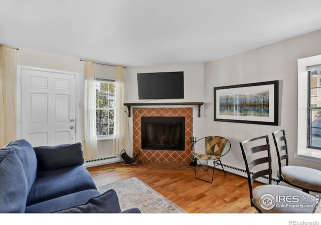 2279 Spruce St Unit 8, Boulder, CO 80302 - living area featuring a baseboard radiator, wood finished floors, and a tiled fireplace