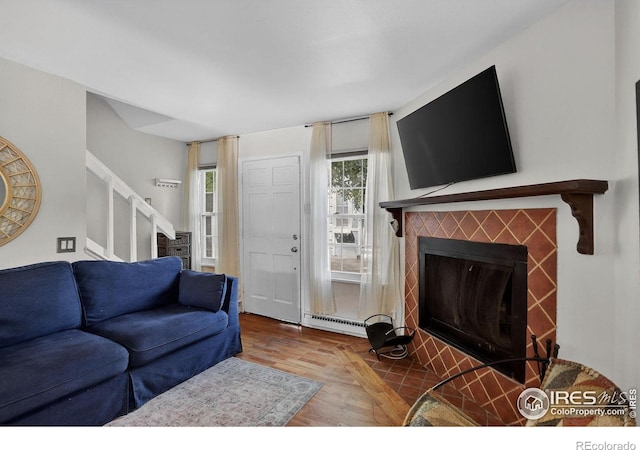 2279 Spruce St Unit 8, Boulder, CO 80302 - living room with a tile fireplace, stairway, wood finished floors, and a baseboard heating unit