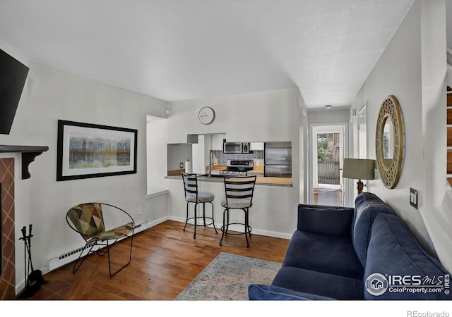 2279 Spruce St Unit 8, Boulder, CO 80302 - living area featuring baseboard heating and wood finished floors