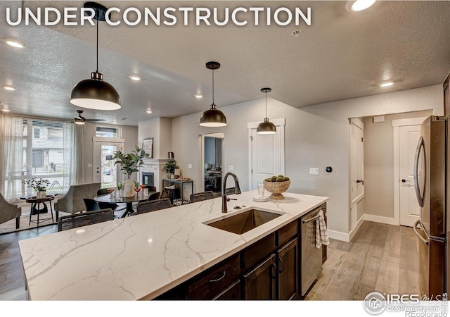 265 High Point Dr Unit 202, Longmont, CO 80504 - kitchen featuring stainless steel appliances, light wood finished floors, open floor plan, dark brown cabinets, and recessed lighting