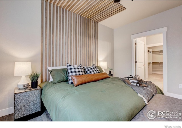 265 High Point Dr Unit 202, Longmont, CO 80504 - bedroom featuring baseboards and a walk in closet