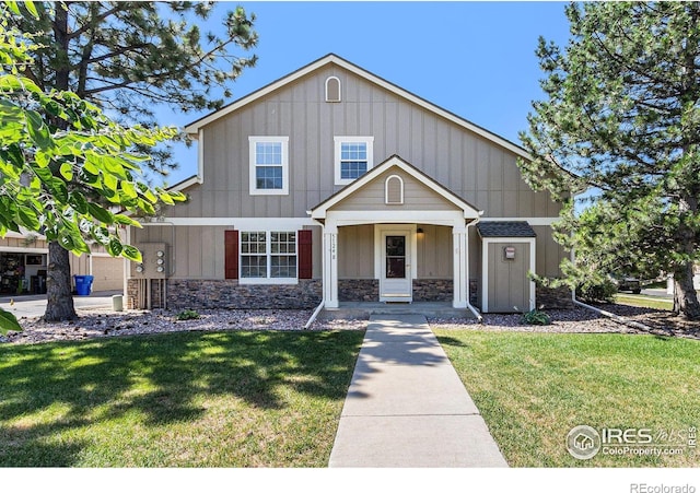 5124 Stillwater Creek Dr Unit E, Fort Collins, CO 80528 - view of front facade with stone siding, a front yard, and board and batten siding