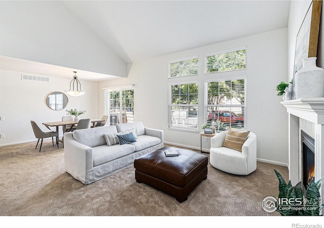 5124 Stillwater Creek Dr Unit E, Fort Collins, CO 80528 - living room featuring carpet, a fireplace with flush hearth, and high vaulted ceiling