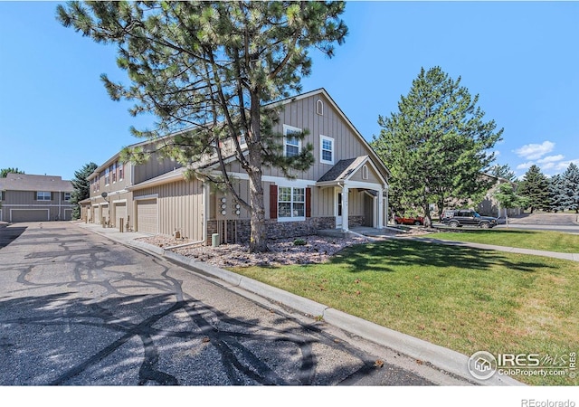 5124 Stillwater Creek Dr Unit E, Fort Collins, CO 80528 - craftsman inspired home with board and batten siding, a front lawn, driveway, a garage, and stone siding