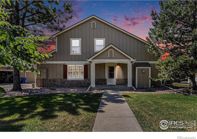 5124 Stillwater Creek Dr Unit E, Fort Collins, CO 80528 - view of front of property with stone siding, a front lawn, and board and batten siding