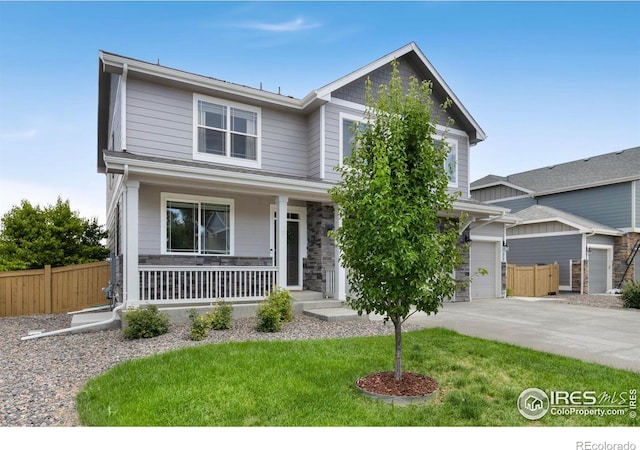 6818 Whisper Trail Ln, Wellington, CO 80549 - craftsman-style home with covered porch, stone siding, a garage, and driveway