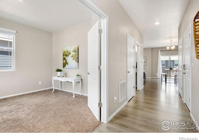 6818 Whisper Trail Ln, Wellington, CO 80549 - corridor featuring a chandelier and wood finished floors