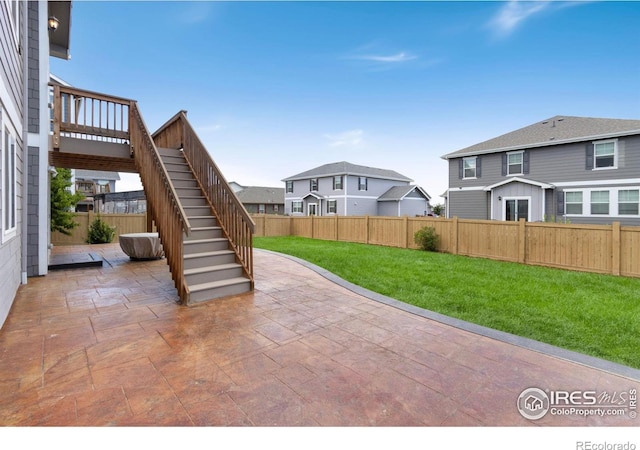 6818 Whisper Trail Ln, Wellington, CO 80549 - fenced backyard with a patio area, stairs, and a residential view