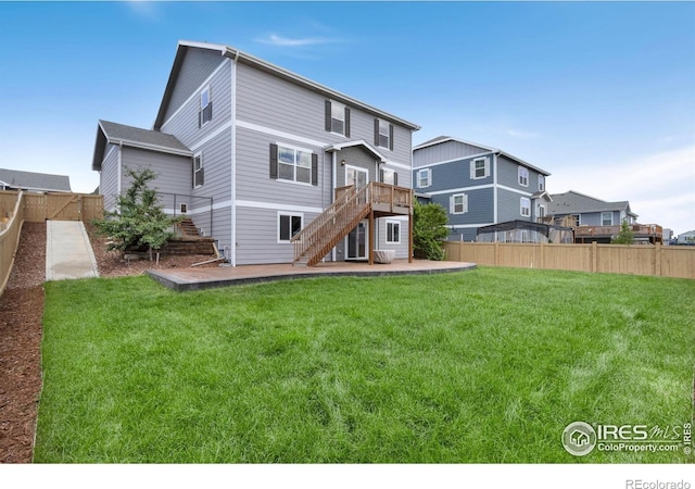6818 Whisper Trail Ln, Wellington, CO 80549 - rear view of property featuring stairway, a fenced backyard, a patio area, and a wooden deck