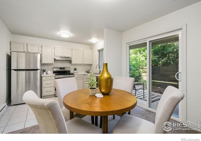 3465 Lochwood Dr Unit N-61, Fort Collins, CO 80525 - dining space featuring light tile patterned floors and baseboards