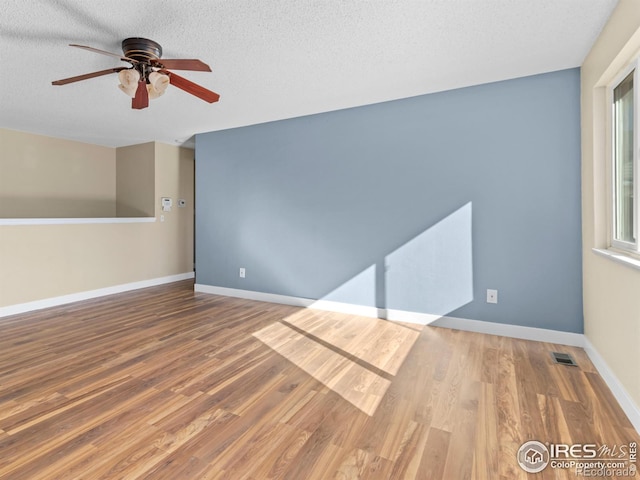 18931 E Brunswick Pl, Aurora, CO 80013 - empty room with ceiling fan, wood finished floors, and a textured ceiling