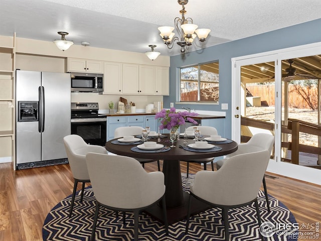 18931 E Brunswick Pl, Aurora, CO 80013 - dining space featuring a chandelier and wood finished floors