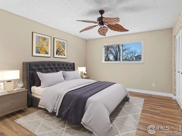 18931 E Brunswick Pl, Aurora, CO 80013 - bedroom featuring wood finished floors, a textured ceiling, and ceiling fan
