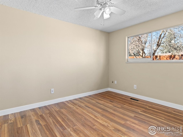 18931 E Brunswick Pl, Aurora, CO 80013 - spare room featuring a textured ceiling, wood finished floors, and ceiling fan