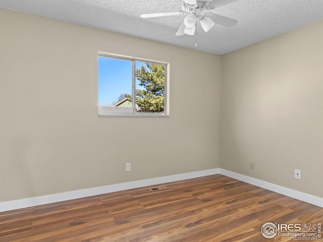 18931 E Brunswick Pl, Aurora, CO 80013 - spare room featuring wood finished floors, a textured ceiling, and a ceiling fan
