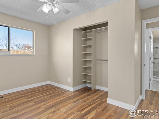 18931 E Brunswick Pl, Aurora, CO 80013 - unfurnished bedroom with a closet, wood finished floors, a textured ceiling, and ceiling fan