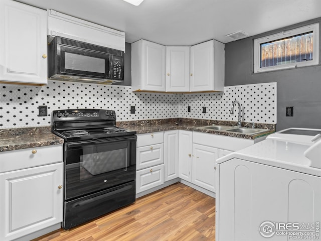 18931 E Brunswick Pl, Aurora, CO 80013 - kitchen with black appliances, washer / dryer, white cabinets, light wood-type flooring, and tasteful backsplash